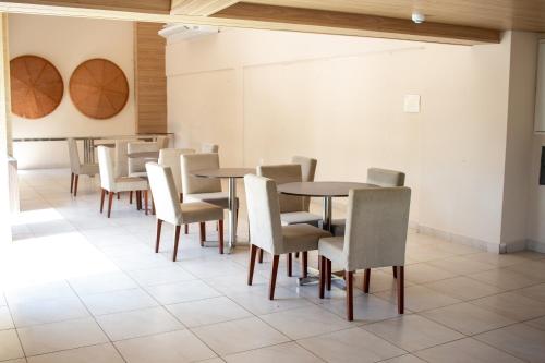 a row of tables and chairs in a room at Apartamento completo/ Verano Ponta Negra- Natal in Natal