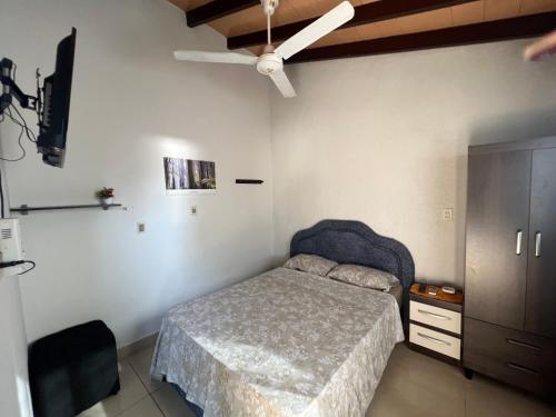 1 dormitorio con 1 cama y ventilador de techo en El sitio, en Luque