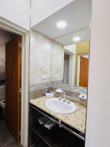 a bathroom with a sink and a mirror at Atuel Alojamiento in San Antonio Oeste