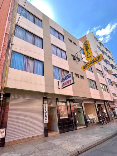 a large building on a street with signs on it at Hostal Escobar in Cochabamba