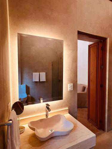 a bathroom with a sink and a large mirror at Casalinda San Miguel in San Miguel de Allende