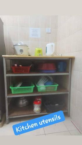 a shelf in a kitchen with utensils at Samma HomeStay Double Storey Terrace House in Kota Kinabalu