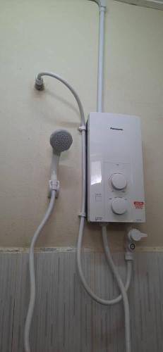 a hair dryer is hooked up to a wall at Homestay Kg Paya D Jitra in Jitra
