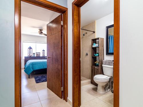a bathroom with a toilet and a bathroom with a bed at Cielomar in Tijuana