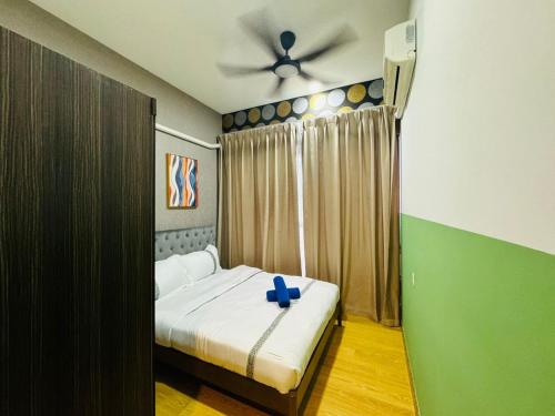 a bedroom with a bed with a blue cross on it at JB Country Garden J Agape Homestay 2106-6A in Johor Bahru