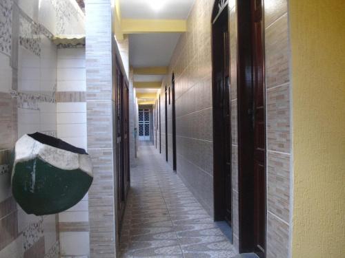 a hallway of a building with a hallwayasteryasteryasteryasteryasteryasteryasteryastery at Residencial Lage Suíte 05-A (Casal+01Beliche) in Porto Seguro