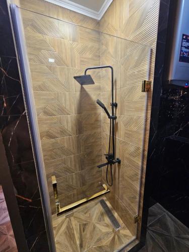 a shower with a glass door in a bathroom at 1 комнатная квартира. Центр. Люкс. in Semey