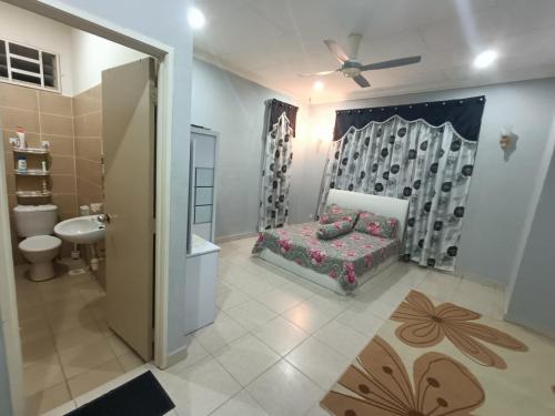 a bathroom with a bed and a sink and a toilet at The Louvre Moslim Homestay Sungai Petani in Sungai Petani