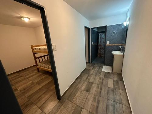 a hallway with a mirror and a sink in a room at El rincon de Valle in Valle Hermoso