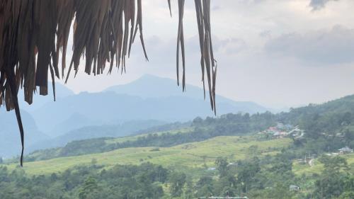 a view of a valley with mountains in the background at Pu Luong Paradise in Hương Bá Thước