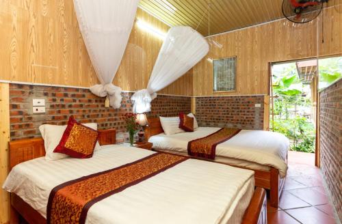 1 dormitorio con 2 camas en una habitación en Hoalu Ecolodge Homestay en Ninh Binh