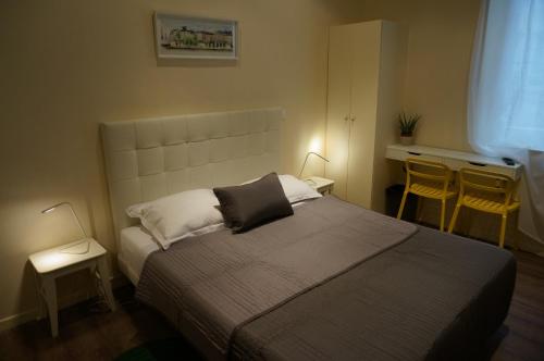 a bedroom with a bed with two tables and two lamps at Hotel Zora in Paris