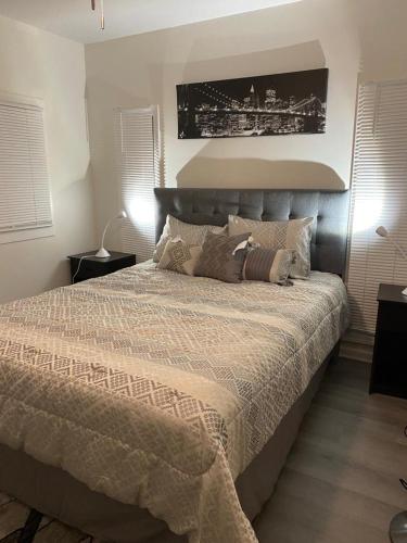 a bedroom with a large bed in a room at EMMAR Blue & Fishing Lake in Charlotte