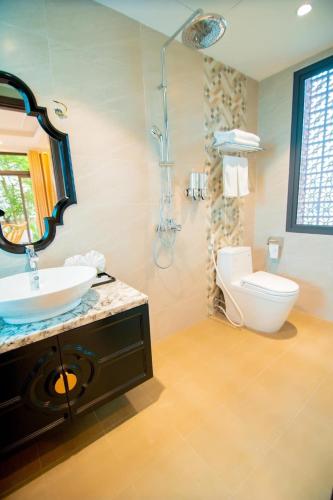 a bathroom with a sink and a toilet at Indochine Ha Long Villa in Ha Long