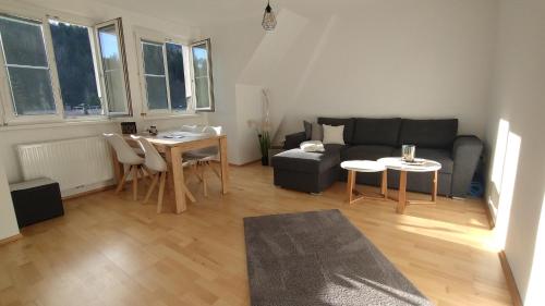 a living room with a couch and a table at City Leaves Apartments in Sankt Aegyd am Neuwalde