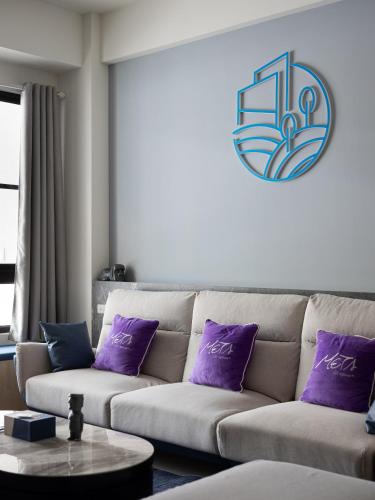 a living room with a couch with purple pillows at Yujing Nu Time in Yujing