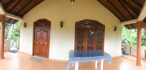 a room with a table in front of a door at Delight Homestay in Ahangama