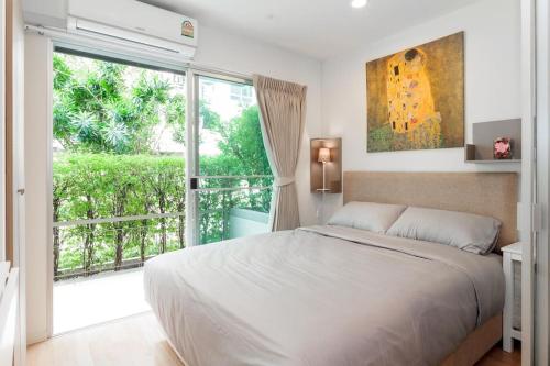 una camera con un grande letto e una grande finestra di Fully Furnished Studio Apartments a Bangkok