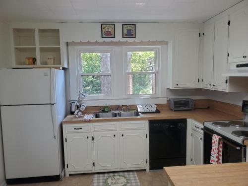 a kitchen with white cabinets and a white refrigerator at Private Single Level Standalone House Large Lot - 3 Bedrooms in Charlotte