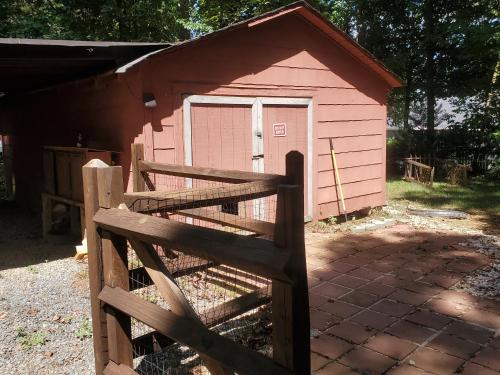 a pink shed with a fence in front of it at Private Single Level Standalone House Large Lot - 3 Bedrooms in Charlotte