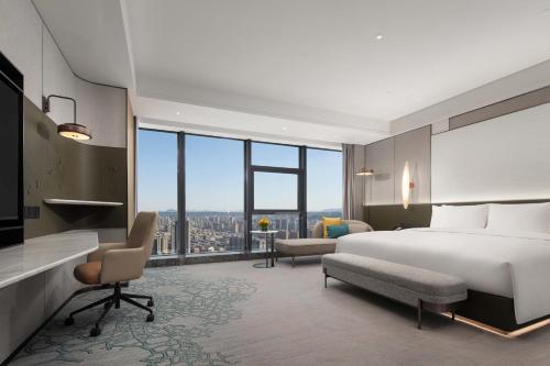 a hotel room with a bed and a large window at Crowne Plaza Jinan Runhua by IHG in Jinan