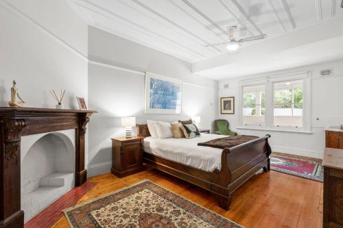 a bedroom with a bed and a fireplace at Clydesville in Queenscliff