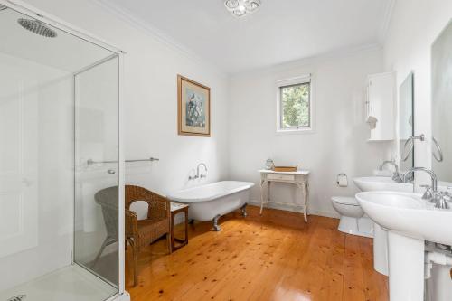 a bathroom with two sinks and a tub and a shower at Clydesville in Queenscliff