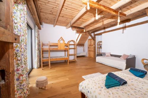 a room with two beds and a bunk bed at Agroturystyka BRYGADZIAKI in Charbielin