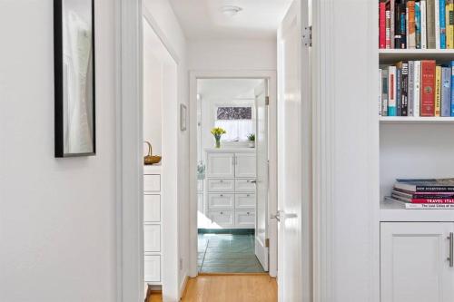 a hallway with white cabinets and a book shelf at Casita Palo Alto - 2 Bed 2 Bath / Private Back Yard in Palo Alto