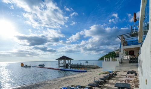 a beach with a gazebo and the ocean at Destino Beach Resort and Hotel in Batangas City