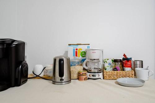 a counter with a coffee maker and other items on it at Richmond Cozy Place 2 in Richmond