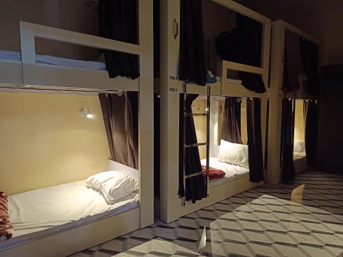 two bunk beds in a room with a mirror at Kashi Vandanam Homestay in Varanasi