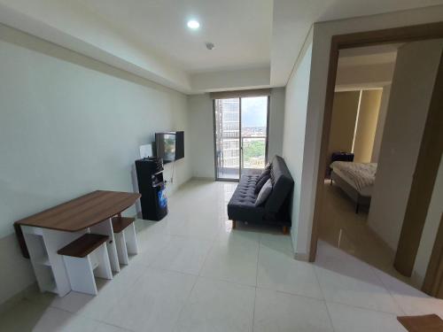 a living room with a couch and a table at 2BedRooms Apartment in Gold Coast PIK in Jakarta