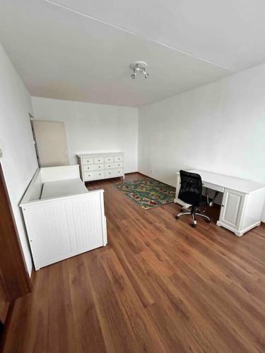 an empty office with a desk and a chair at Celý byt pre vás in Lučenec