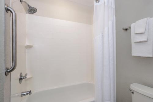 a bathroom with a shower and a toilet at Holiday Inn Express & Suites Jacksonville South - I-295 by IHG in Jacksonville