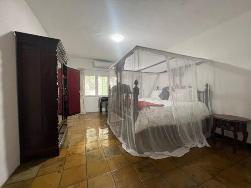 a bedroom with a bed covered in mosquito nets at BEACH FRONT VILLA in Malindi