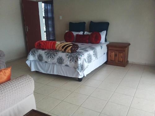 ein Schlafzimmer mit einem Bett mit Kissen darauf in der Unterkunft Protea Avenue Margate in Margate