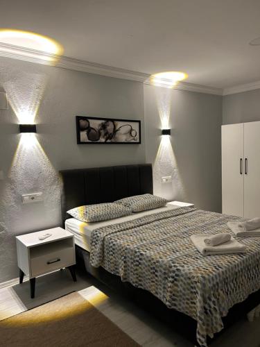 a bedroom with a large bed and a white cabinet at Turgutsluxury 4 in Fethiye