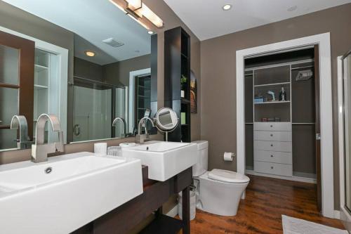 a bathroom with two sinks and a toilet at Luxury Condo in Akron Northside District in Akron