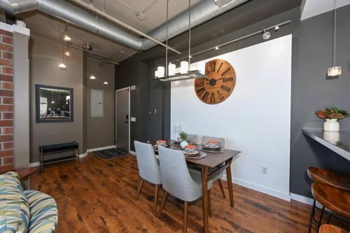 a dining room with a table and chairs and a clock at Luxury Condo in Akron Northside District in Akron