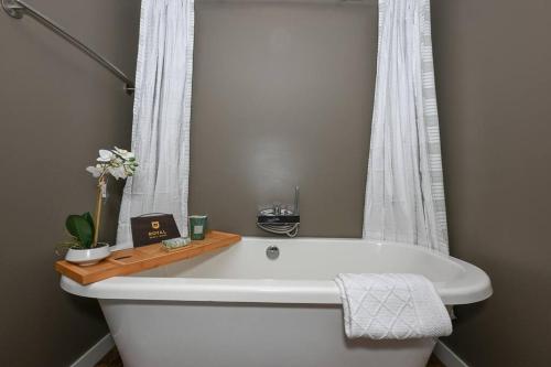a white bath tub in a bathroom with a window at Luxury Condo in Akron Northside District in Akron