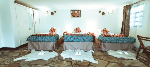 a group of three tables in a room at Davinci Gorilla Lodge in Kinigi