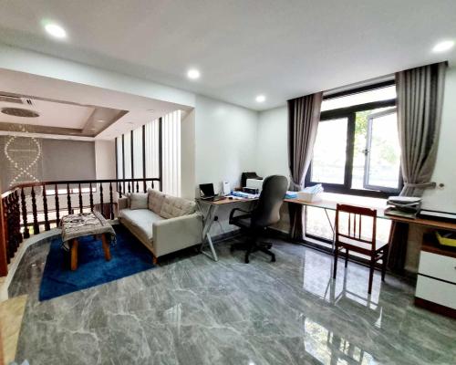 an office with a desk and a couch and a chair at Homestay Thule in Ho Chi Minh City