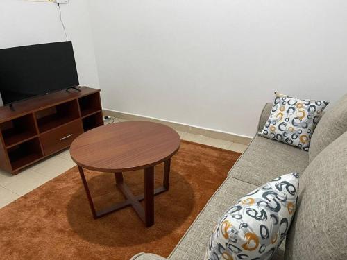 a living room with a coffee table and a couch at The Hillmaac Nest 1 Eldoret in Eldoret