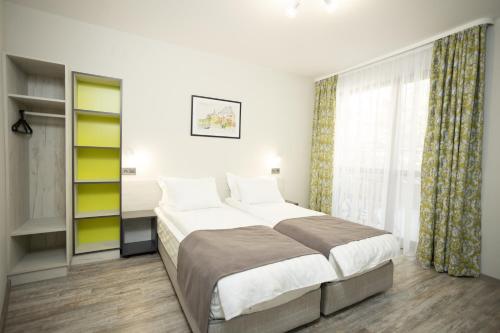 a bedroom with a large bed and a window at Arima city in Shumen