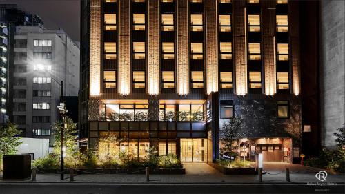 a tall building with lights on the front of it at Daiwa Roynet Hotel Shimbashi in Tokyo