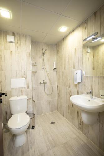 a bathroom with a toilet and a sink at Arima city in Shumen