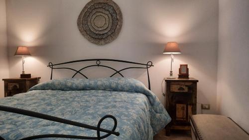 1 dormitorio con 1 cama, 2 mesitas de noche y 2 lámparas en Casa Vacanza - Antico Attico, en Monteroni di Lecce