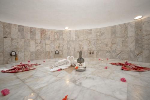 a room with pink rose petals on the floor at Kustur Club Holiday Village - All Inclusive in Kusadası