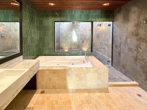 a large bathroom with a tub and a shower at Bonheur at Karambunai in Kota Kinabalu